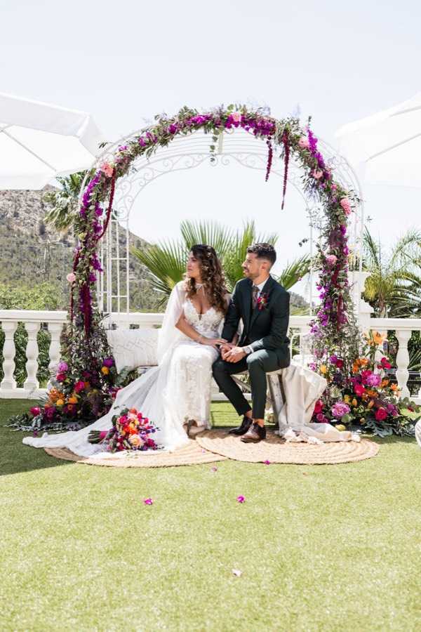 Ceremonia de la boda de Cristina y José bajo un arco floral